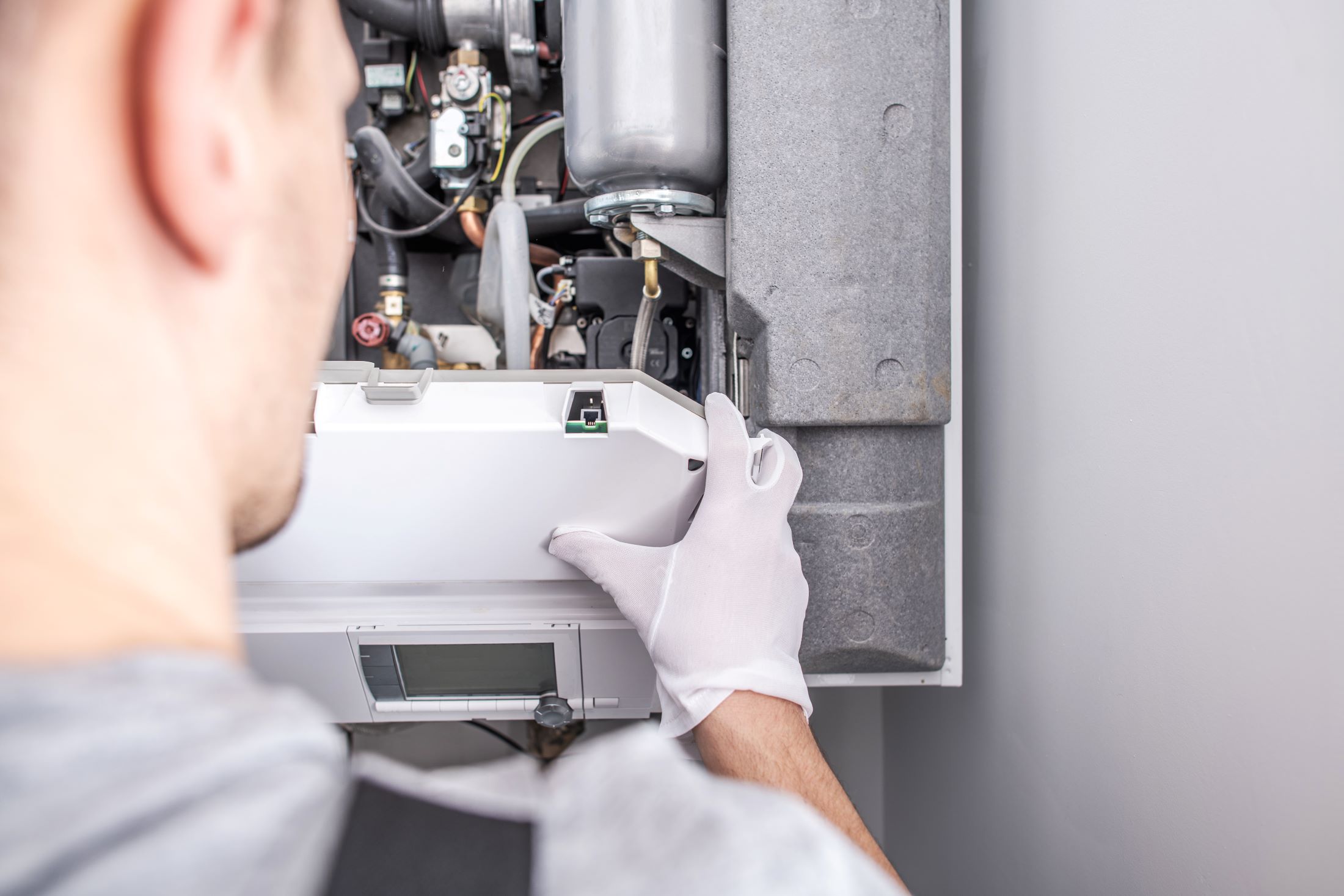 technician repairing furnace system